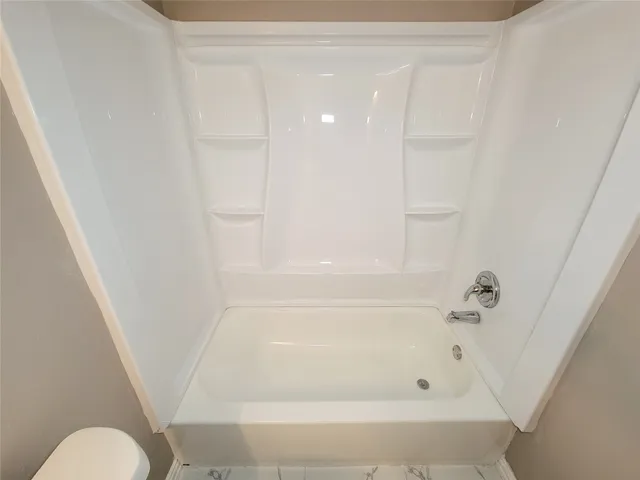 a bathroom with a bathtub a sink and a mirror