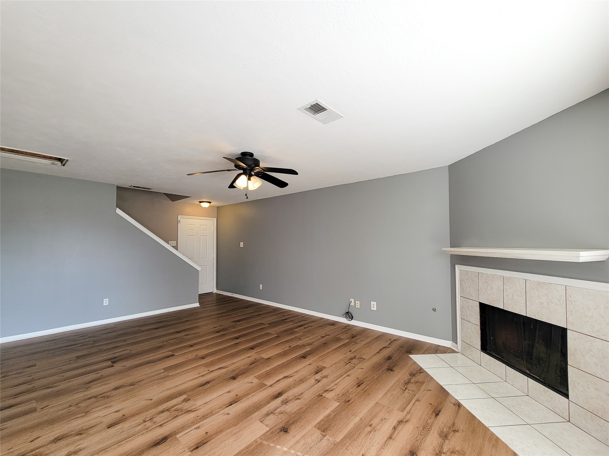 18335 Westlock Street Tomball, TX 77377 - Photo 3 of 38 a view of empty room with wooden floor and fireplace