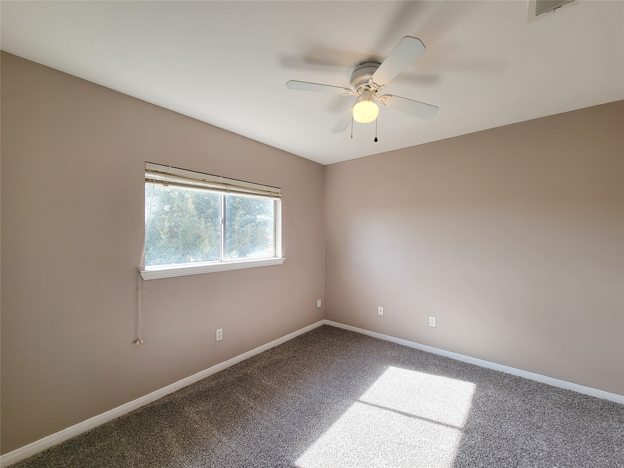18335 Westlock Street Tomball, TX 77377 - Photo 37 of 38 an empty room with a window and a fan