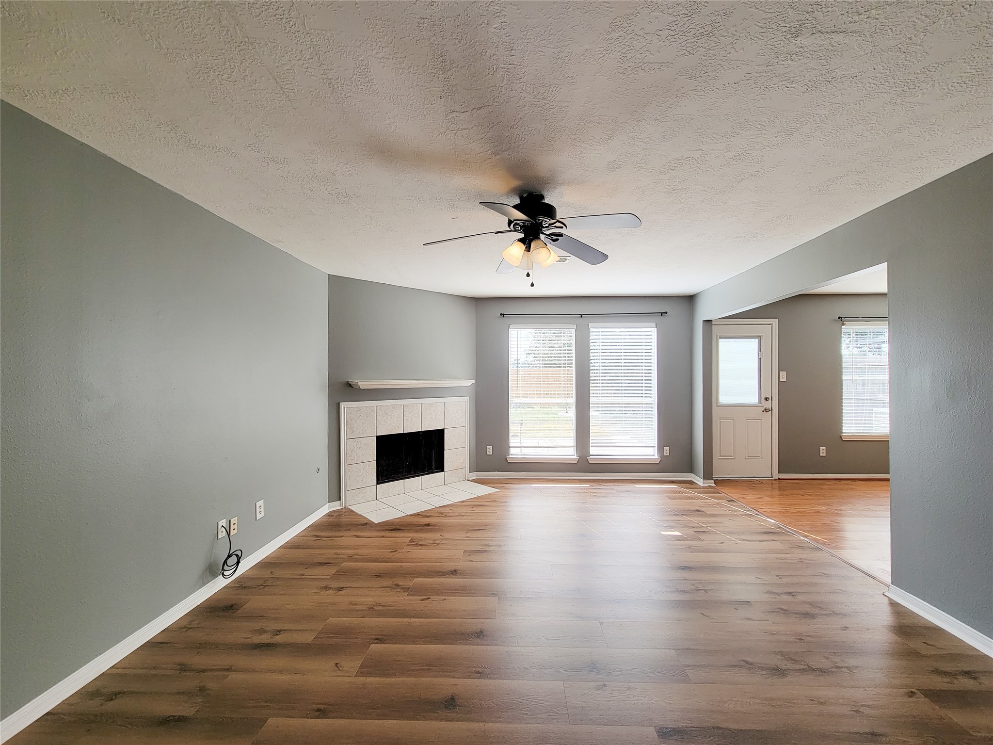 18335 Westlock Street Tomball, TX 77377 - Photo 5 of 38 a view of an empty room with window and wooden floor