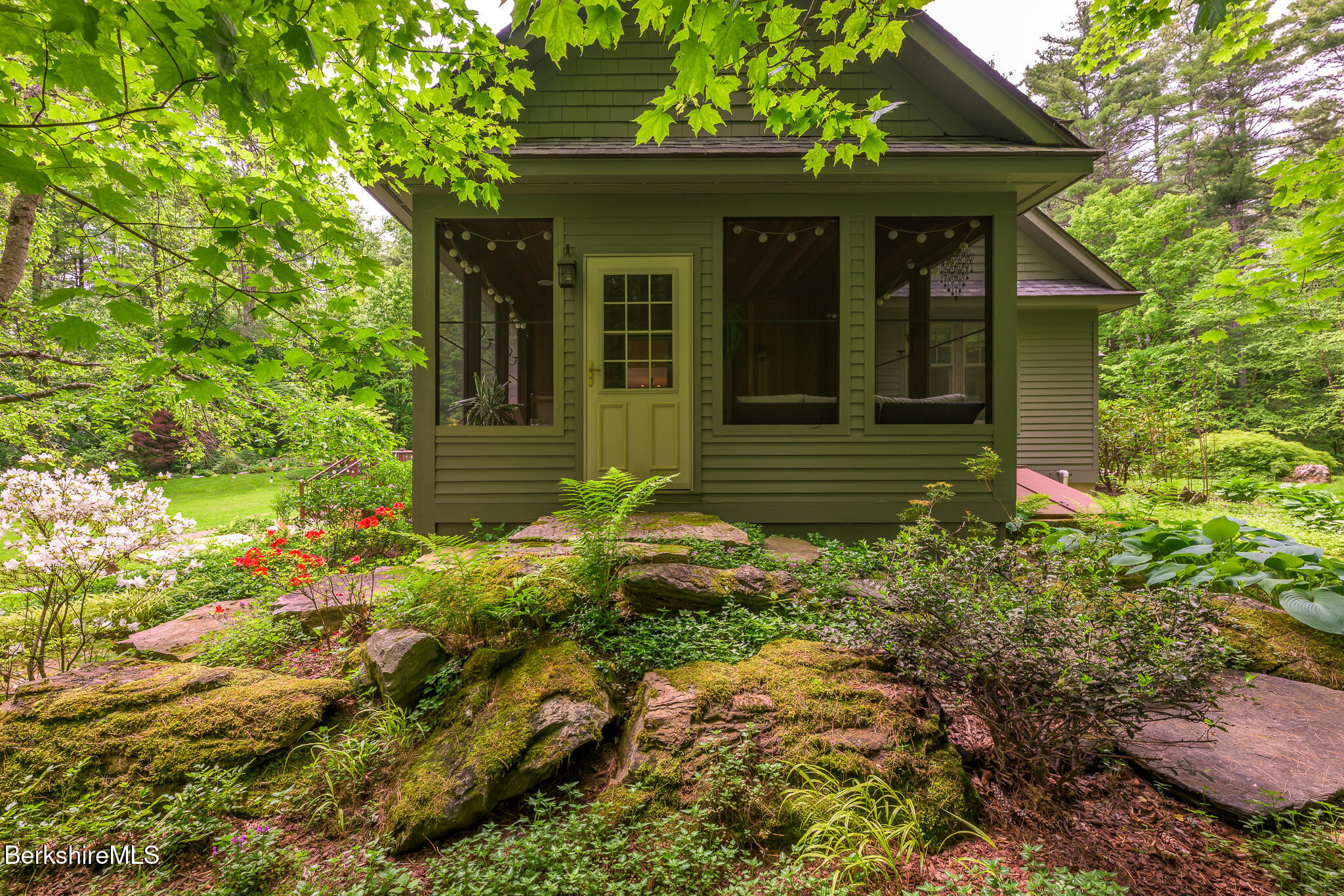 430 Lenox Road Richmond, MA 01254 - Photo 63 of 66 a yellow house with flower garden in front of it