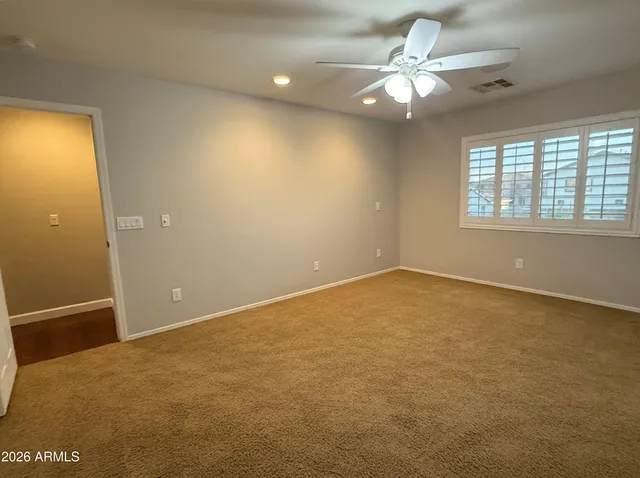a view of a livingroom with a chair and wooden floor