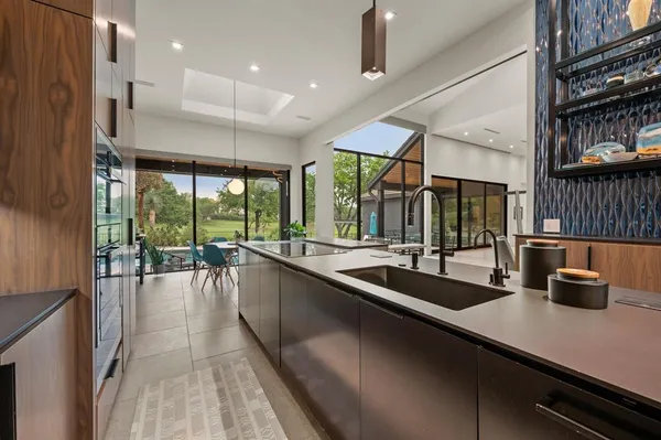 a kitchen with a sink and wooden floor