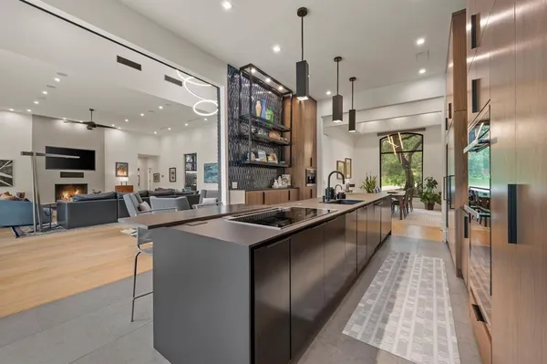 a large kitchen with a large counter top appliances and cabinets