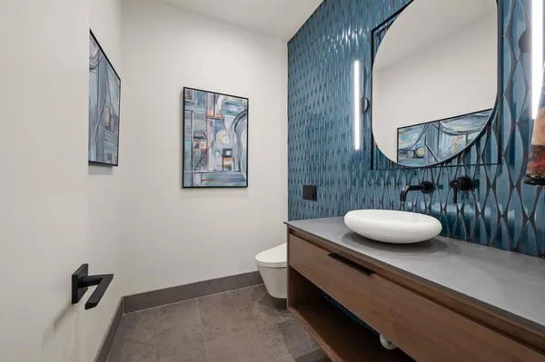 a bathroom with a toilet a sink and mirror