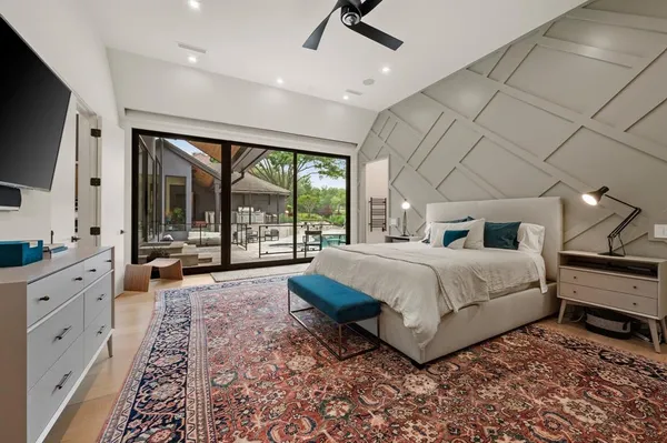 a spacious bedroom with a large bed and a large window