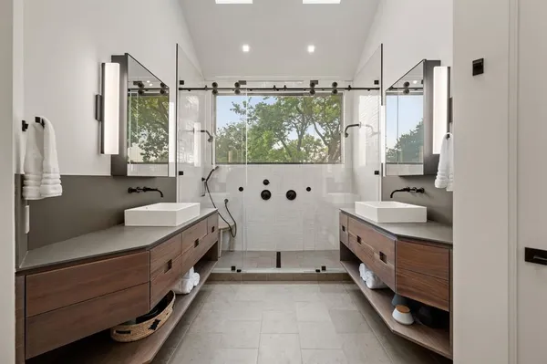 a spacious bathroom with double vanity and a bathtub