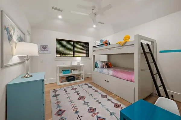 a bedroom with furniture and a flat screen tv