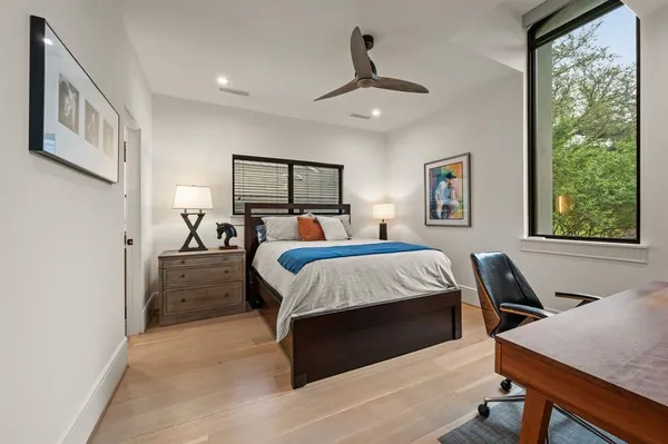 a bedroom with a bed and wooden floor