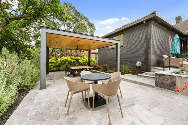 a backyard of a house with a table and chairs