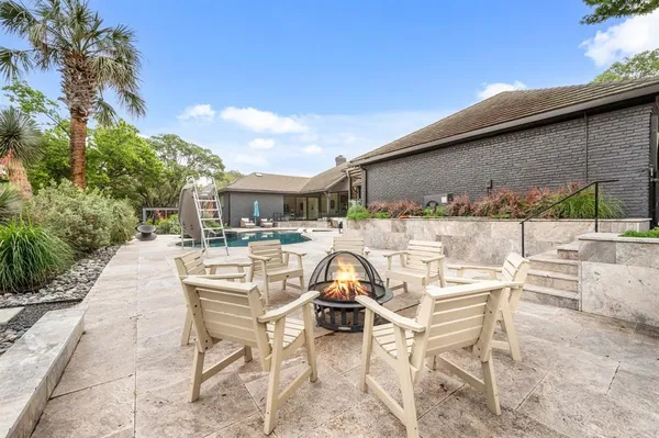 a view of a patio with table and chairs and potted plants