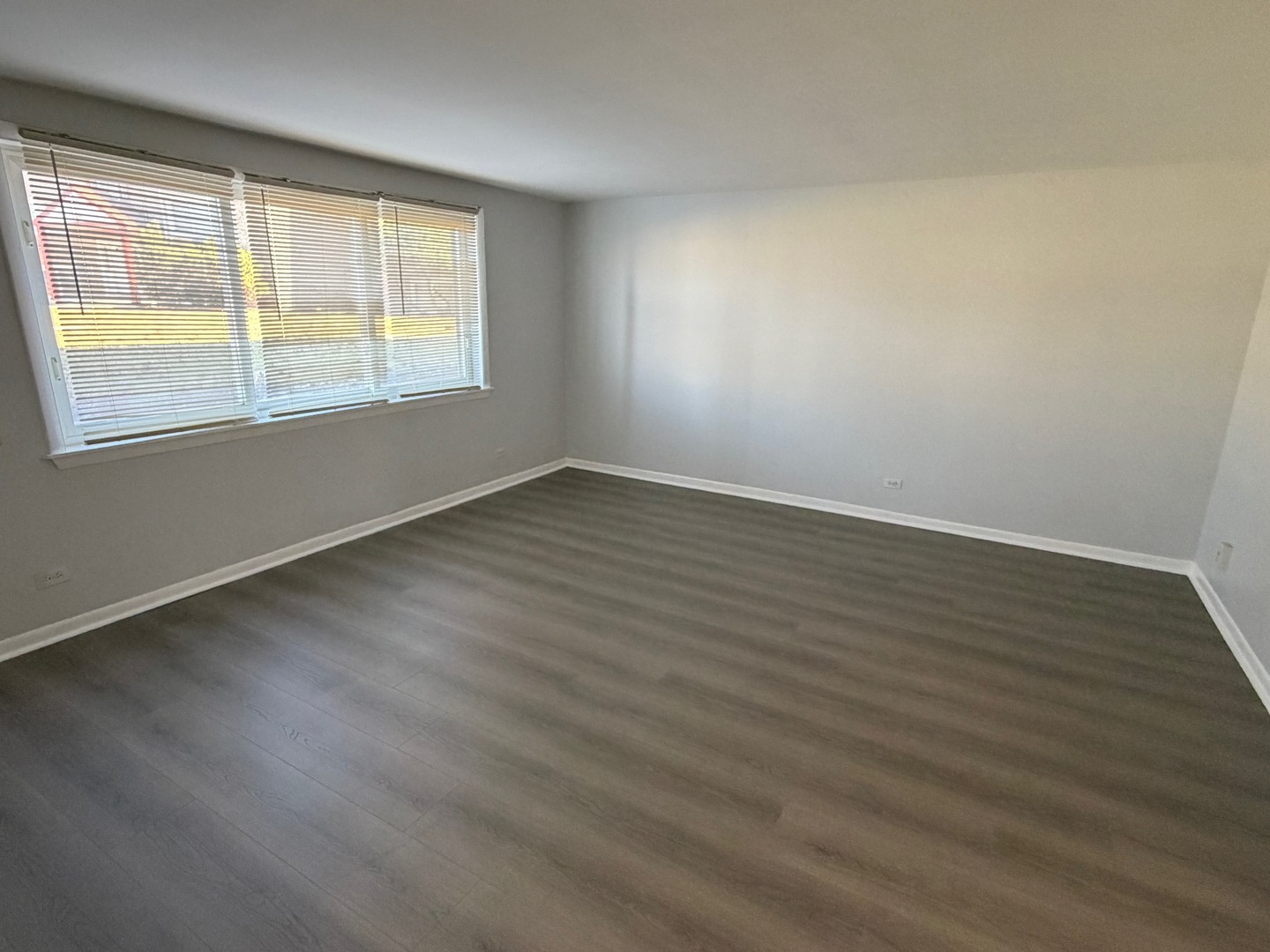 1110 18th Street, Unit GE Broadview, IL 60155 - Photo 4 of 20 a view of an empty room with wooden floor and a window