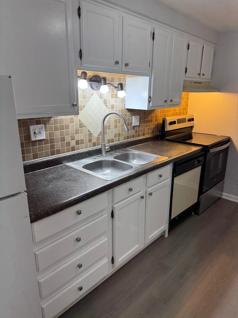 1110 18th Street, Unit GE Broadview, IL 60155 - Photo 6 of 20 a kitchen with granite countertop white cabinets and sink