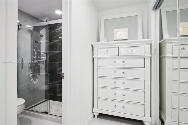 a white toilet sitting next to a bathroom sink