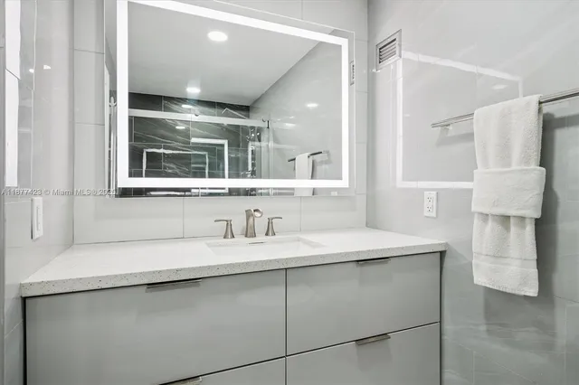 a bedroom with double vanity and a large window