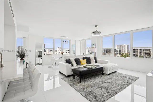 a living room with furniture and a kitchen view