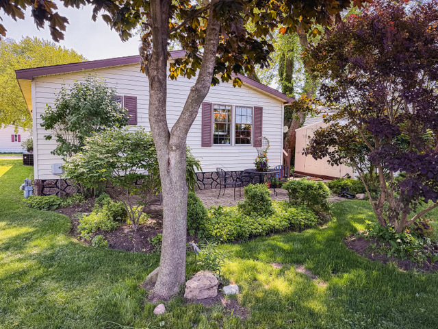 38569 North Sheridan Road, Unit 390 Beach Park, IL 60099 - Photo 28 of 28 a front view of a house with garden
