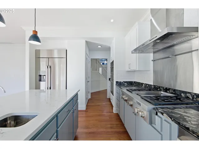 a kitchen with granite countertop a sink and stove