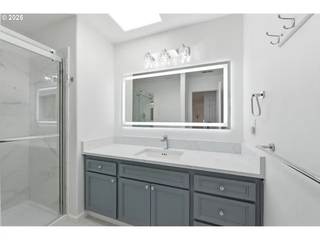 a bathroom with a sink vanity and a mirror
