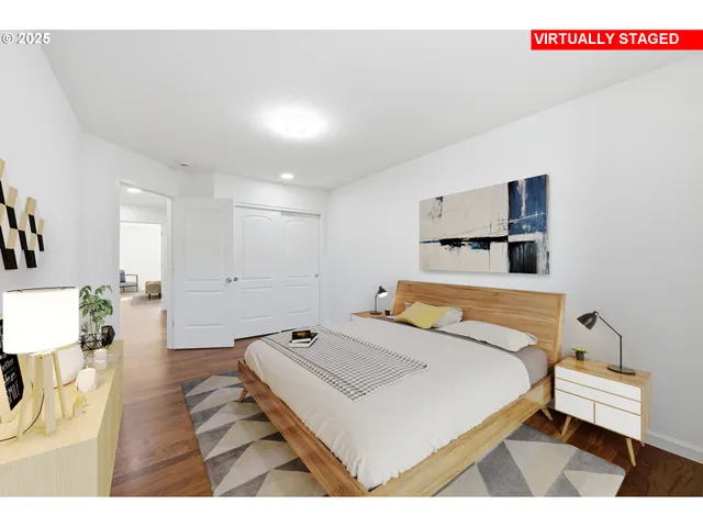 a bedroom with a bed and a night stand