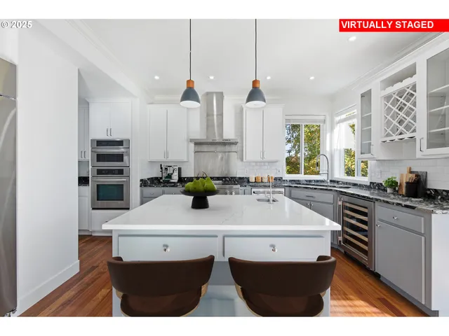 a kitchen with kitchen island cabinets a sink and appliances
