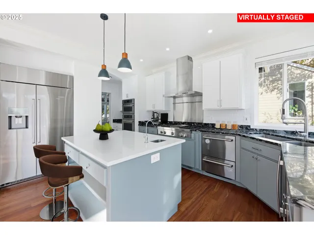 a kitchen with kitchen island a stove a table and chairs in it