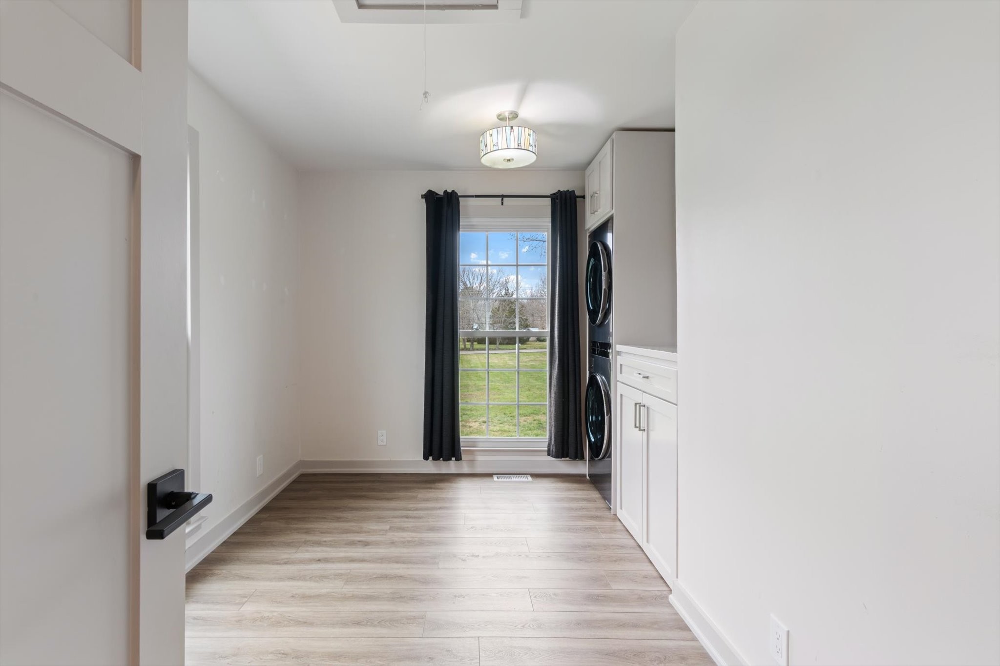 4158 Arno Road Franklin, TN 37064 - Photo 28 of 44 a view of a hallway to a livingroom with wooden floor and a chandelier