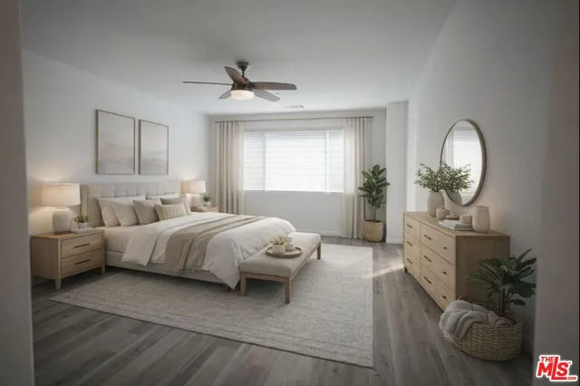 a spacious bedroom with a bed mirror and window