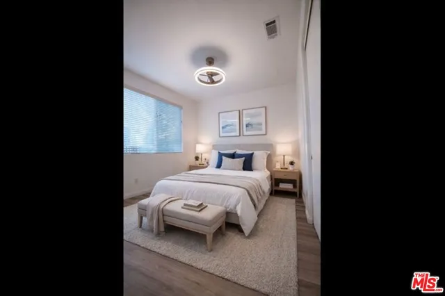 a bedroom with a bed and a night stand