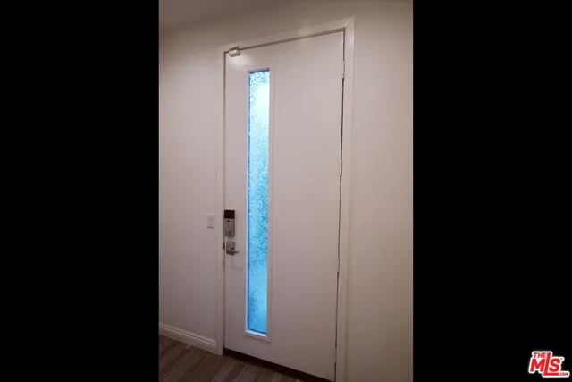 a view of front door with wooden floor