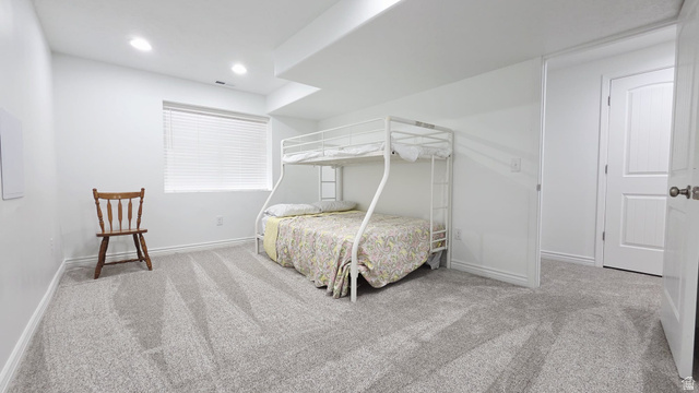 1437 925 South Vernal, UT 84078 - Photo 30 of 47 Spacious room featuring light gray carpeting, recessed lighting, a window with horizontal blinds, and white interior doors
