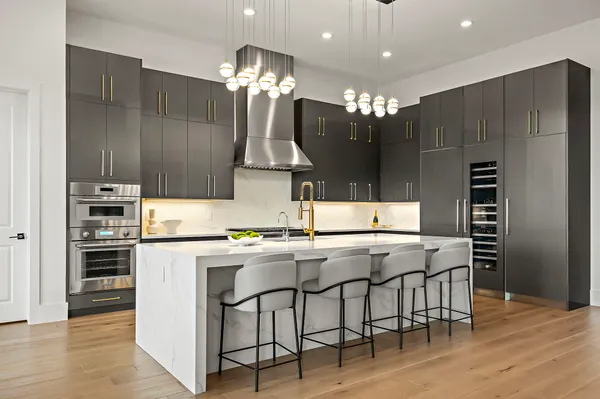 a kitchen with kitchen island a sink stove and refrigerator