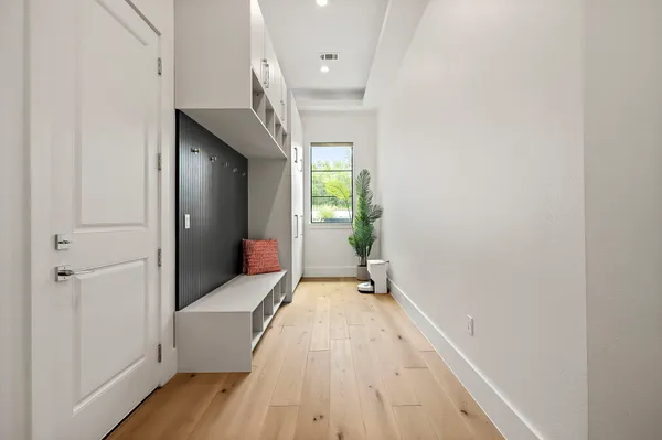 a view of hallway with wooden floor