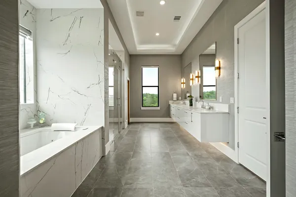 a large white bathroom with a large mirror vanity and shower