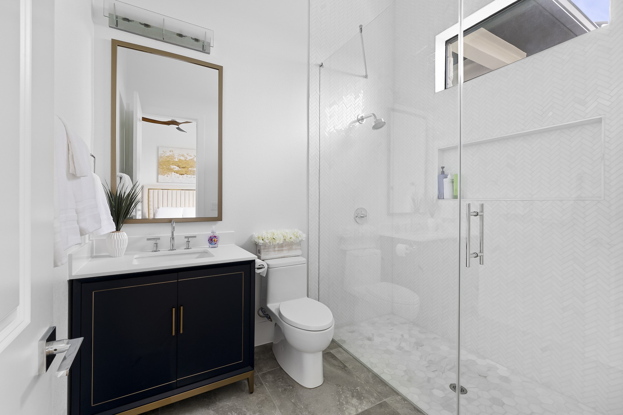 10211 Thistle Ridge Austin, TX 78733 - Photo 24 of 39 a bathroom with a granite countertop sink toilet a mirror and shower