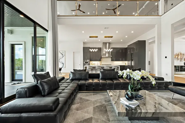 a living room with kitchen island furniture and a potted plant