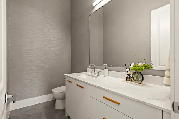 a bathroom with a sink a toilet and a window