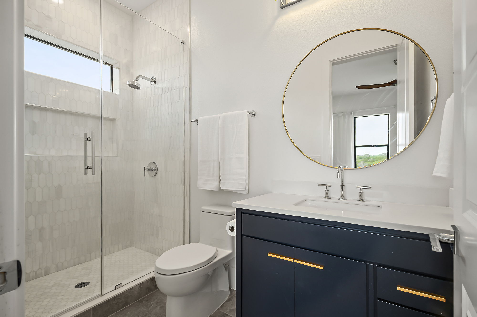 10211 Thistle Ridge Austin, TX 78733 - Photo 35 of 39 a bathroom with a sink a toilet and shower