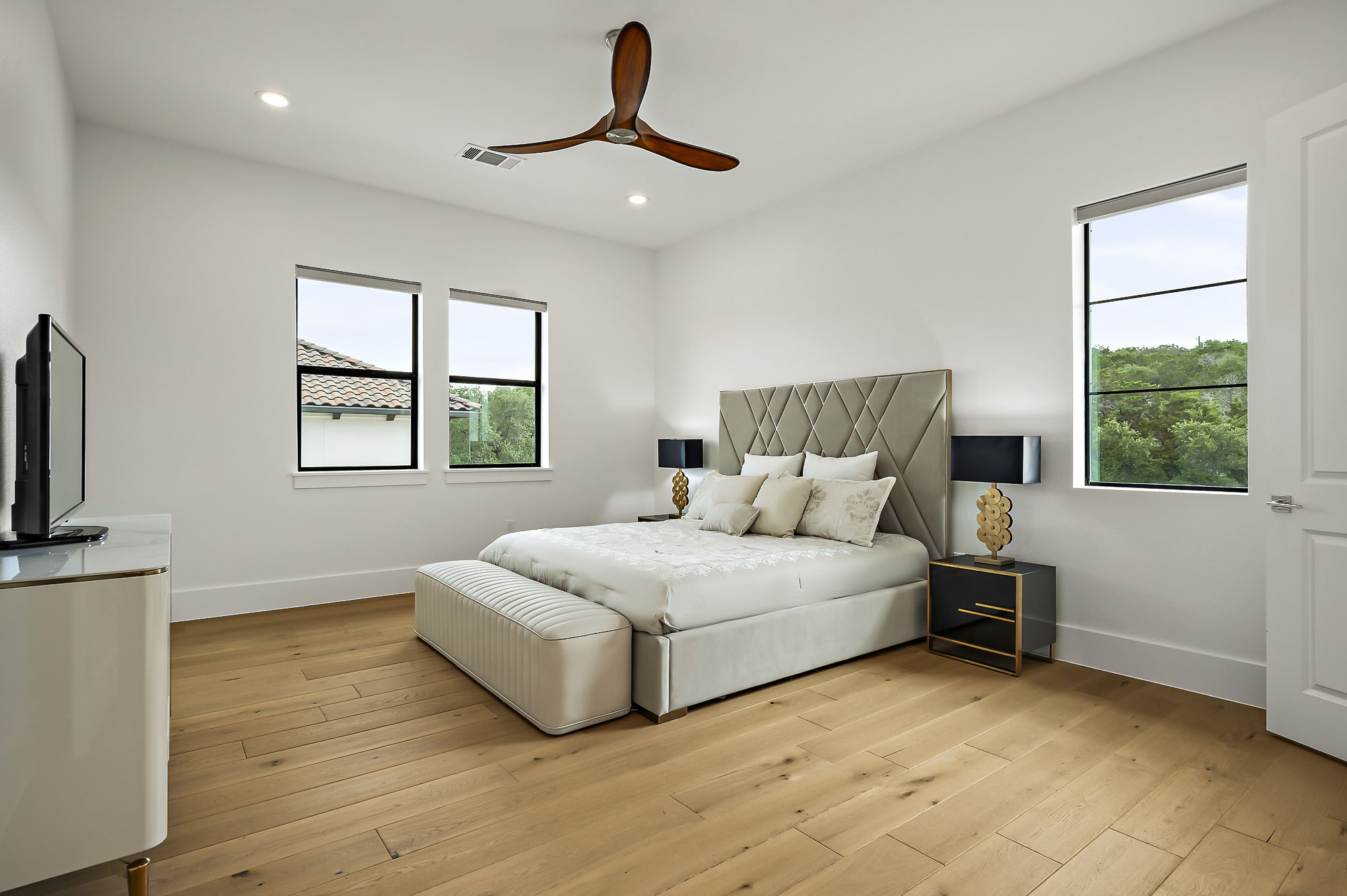 10211 Thistle Ridge Austin, TX 78733 - Photo 36 of 39 a bedroom with a large bed and a window