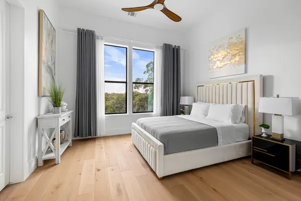 a large bed sitting in a bedroom next to a window
