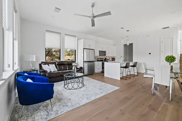 a living room with furniture and kitchen view