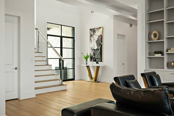 a living room with furniture and wooden floor