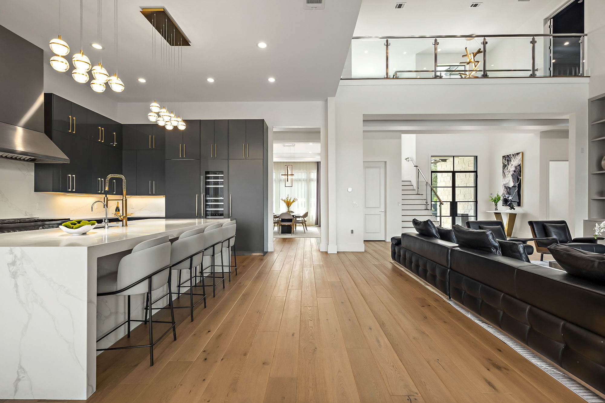 10211 Thistle Ridge Austin, TX 78733 - Photo 6 of 39 a large kitchen with kitchen island a stove a sink dishwasher and a dining table with wooden floor