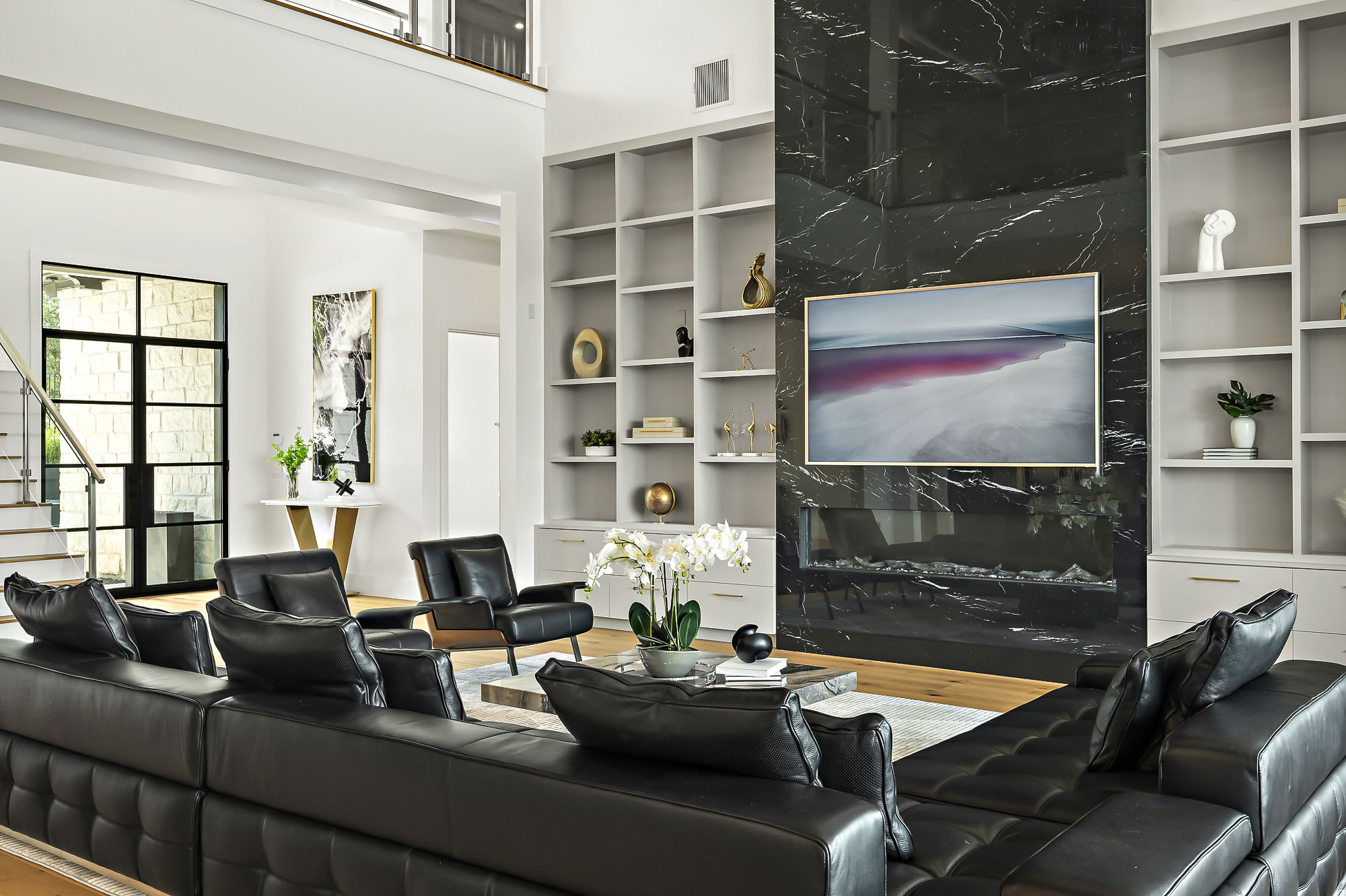 10211 Thistle Ridge Austin, TX 78733 - Photo 7 of 39 a living room with furniture a flat screen tv and a floor to ceiling window