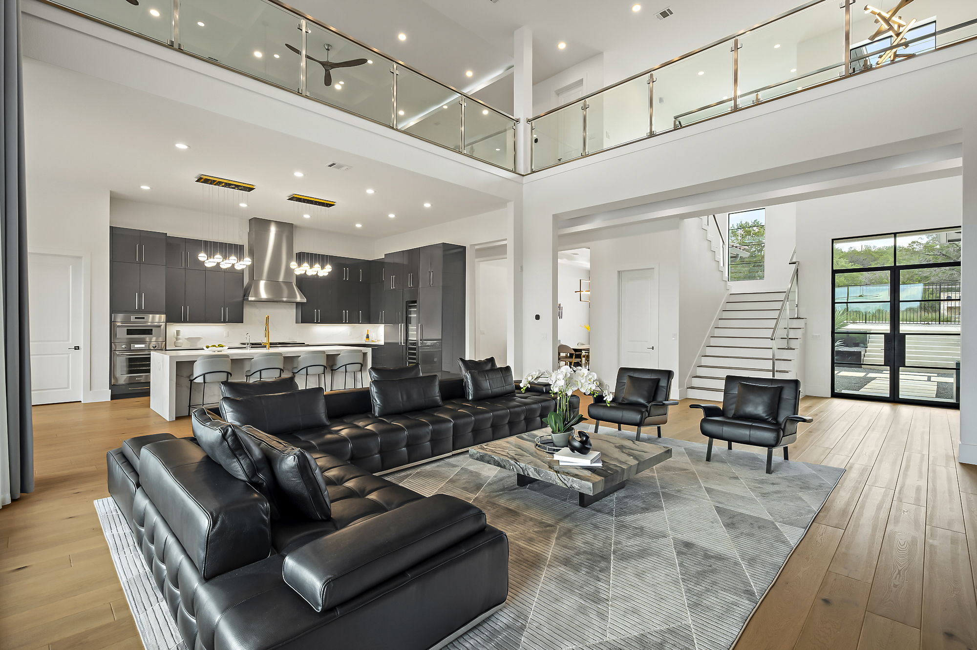 10211 Thistle Ridge Austin, TX 78733 - Photo 8 of 39 a living room with furniture kitchen view and a large window