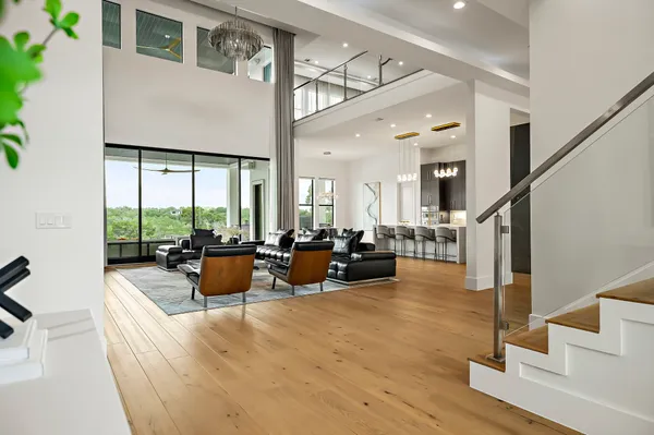 a living room with fireplace furniture and a large window