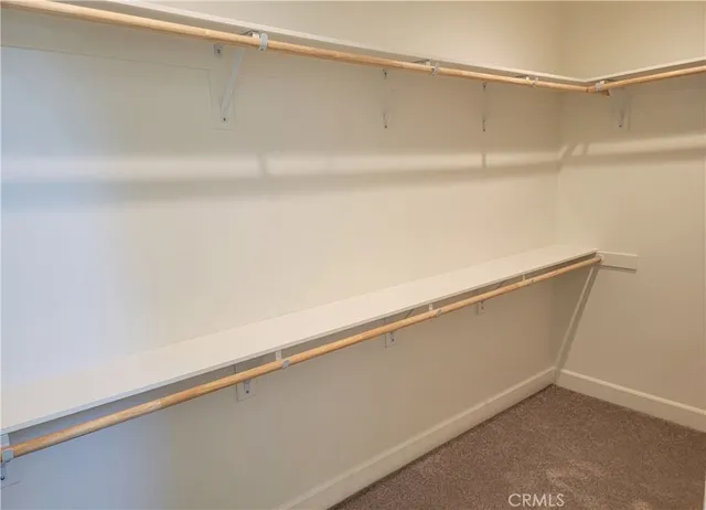 a view of a kitchen with white cabinets