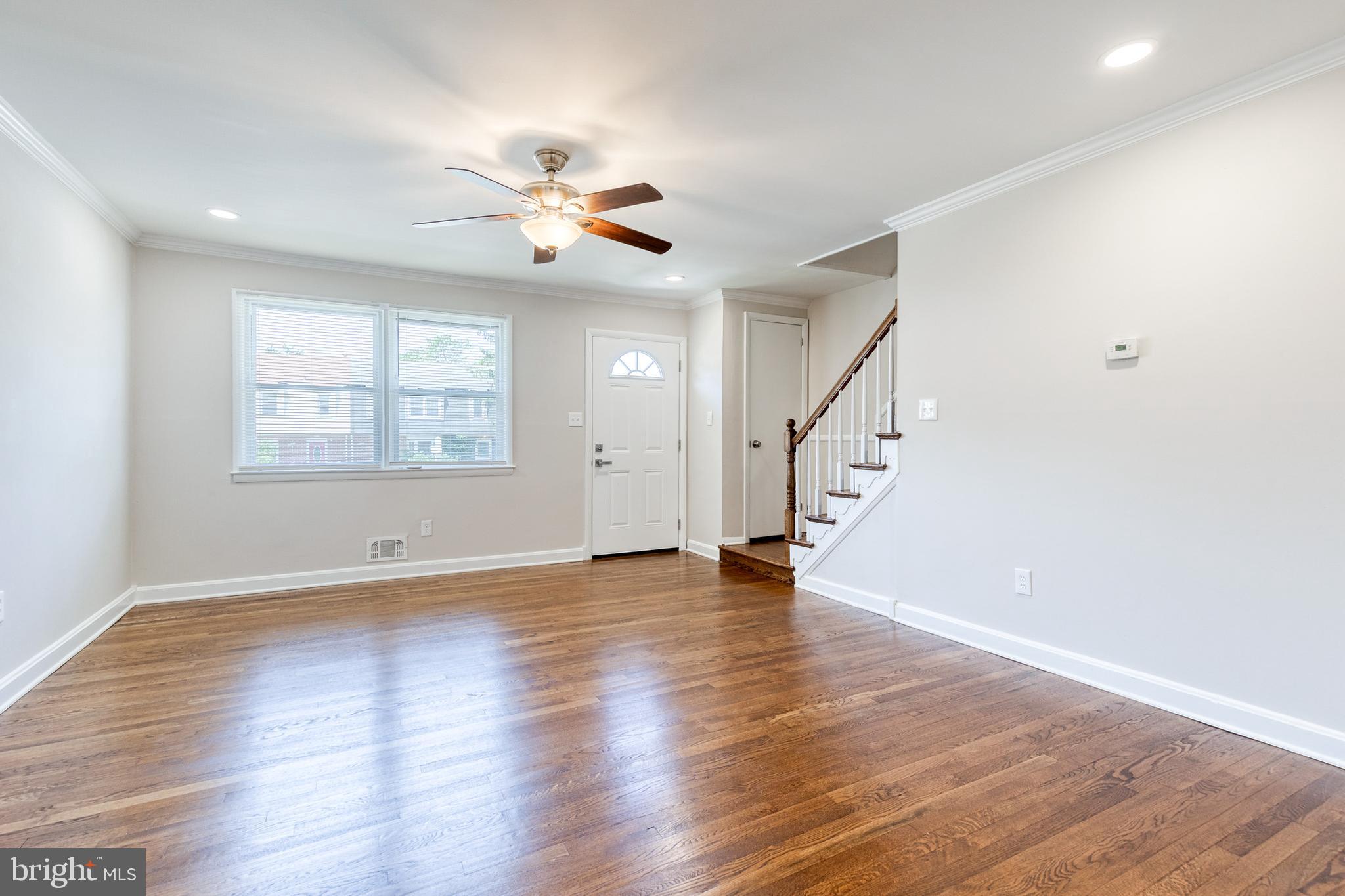 5649 Utrecht Road Baltimore, MD 21206 - Photo 8 of 42 a view of an empty room with wooden floor and a window