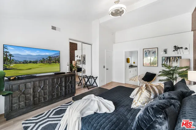 a bedroom with furniture and a large window