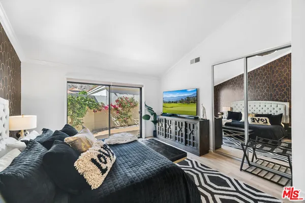 a bedroom with furniture and a window